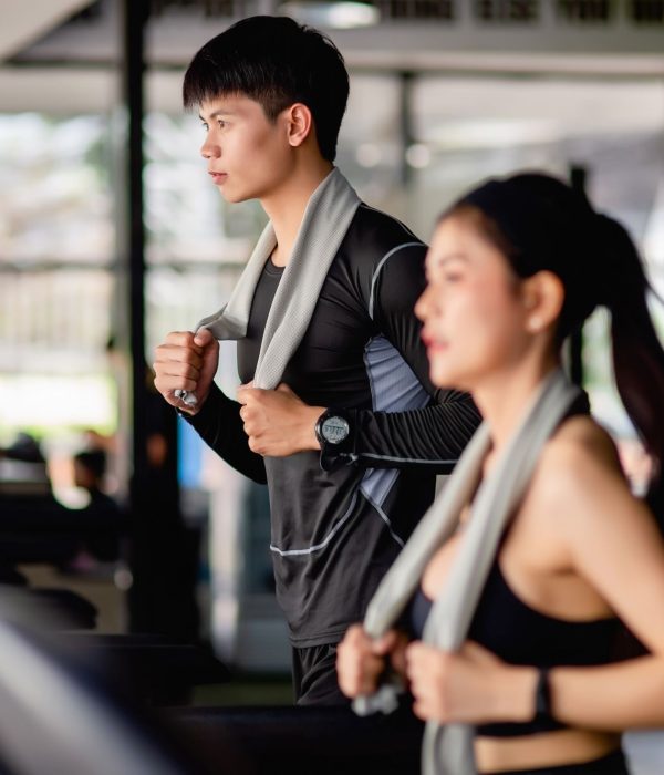 selective-focus-young-man-blurred-young-sexy-woman-foreground-wearing-sportswear-smartwatch-they-are-running-treadmill-workout-modern-gym